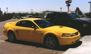 Yellow 1999 Ford Mustang GT and Black Ford F150 Lightning